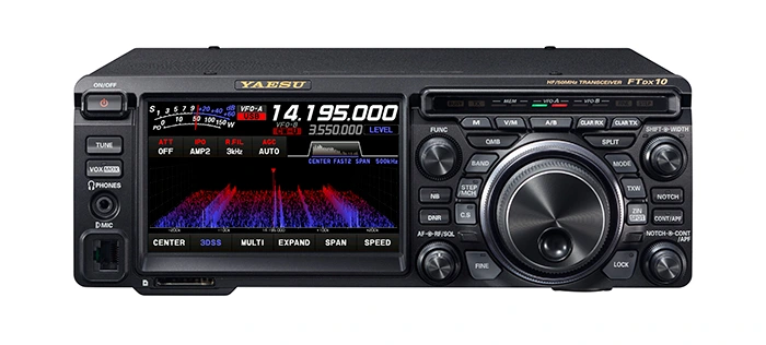 Yaesu FTDX10 product presentation on a warm cream background with its built-in 3DSS spectrum display